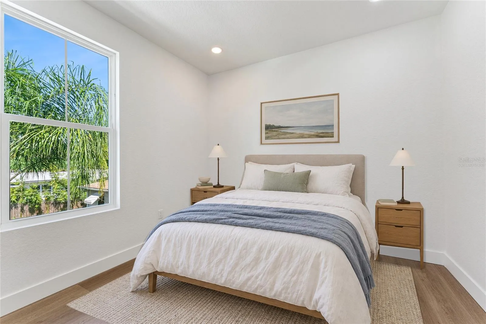 Virtually Staged - A tall window brings natural light and a leafy outlook into this room.