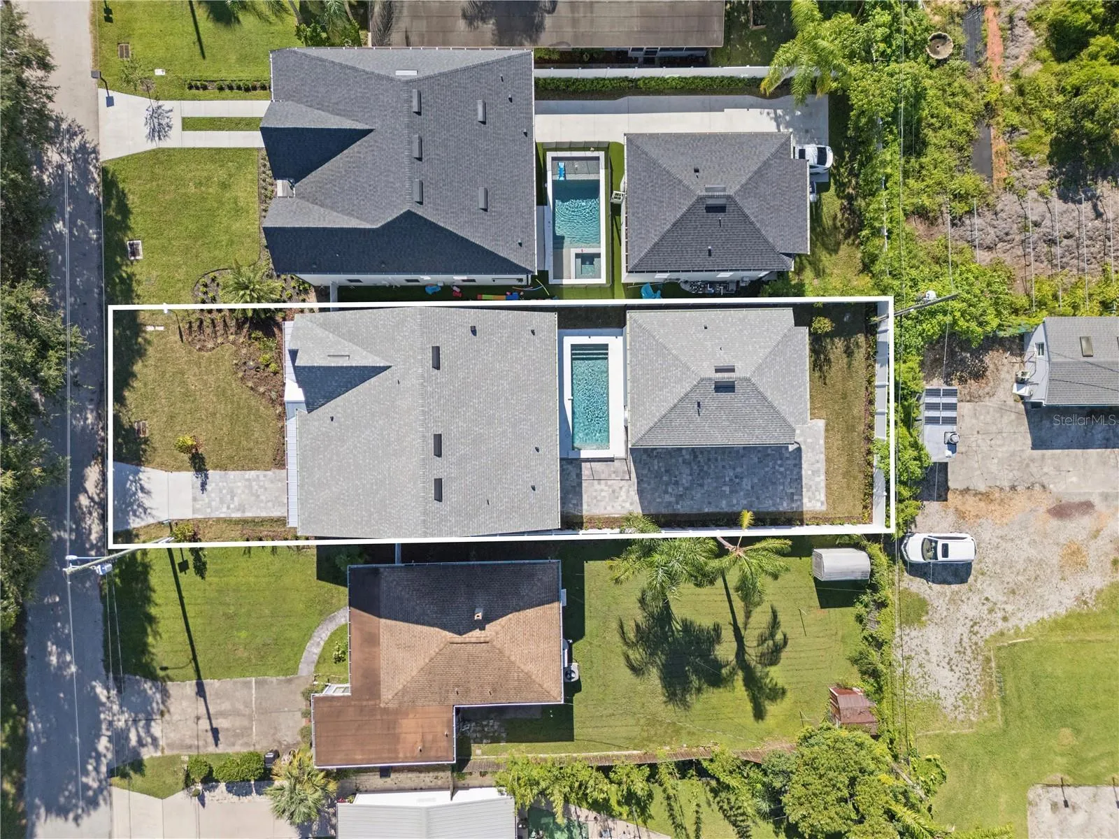 An overhead view shows the home, pool, and rear garage; neighboring properties are also pictured.
