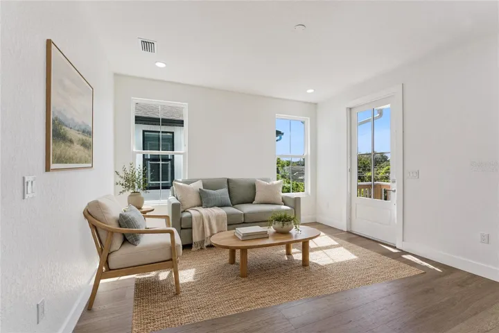 Virtually Staged - Tall windows and a glazed exterior door bring light into this room.