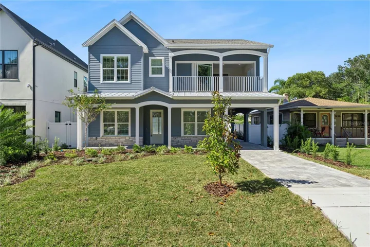 Welcoming front exterior with gabled rooflines, a covered porch, and an upper-level balcony.