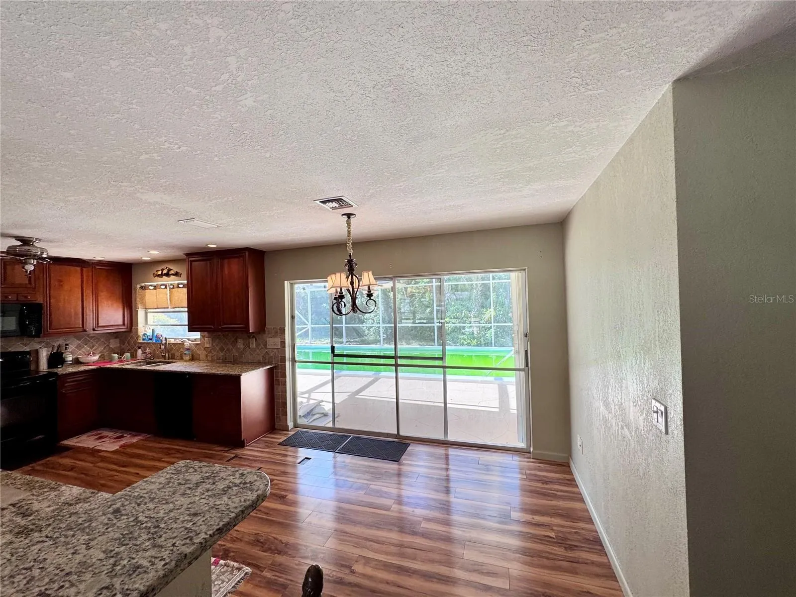 Kitchen/dining area with sliders out to pool