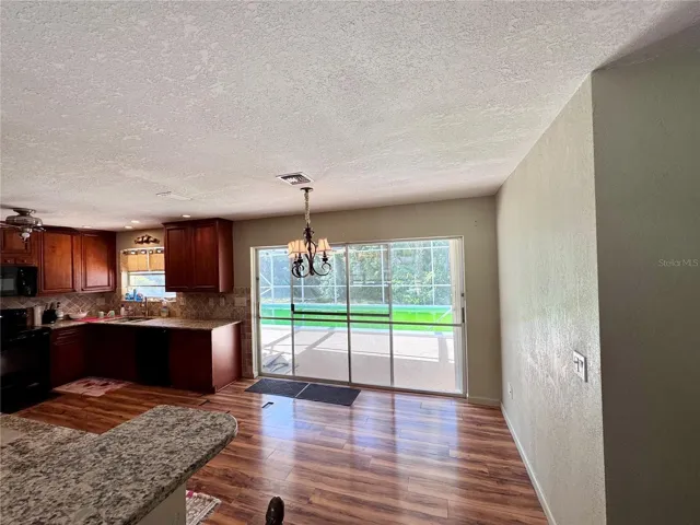 Kitchen/dining area with sliders out to pool