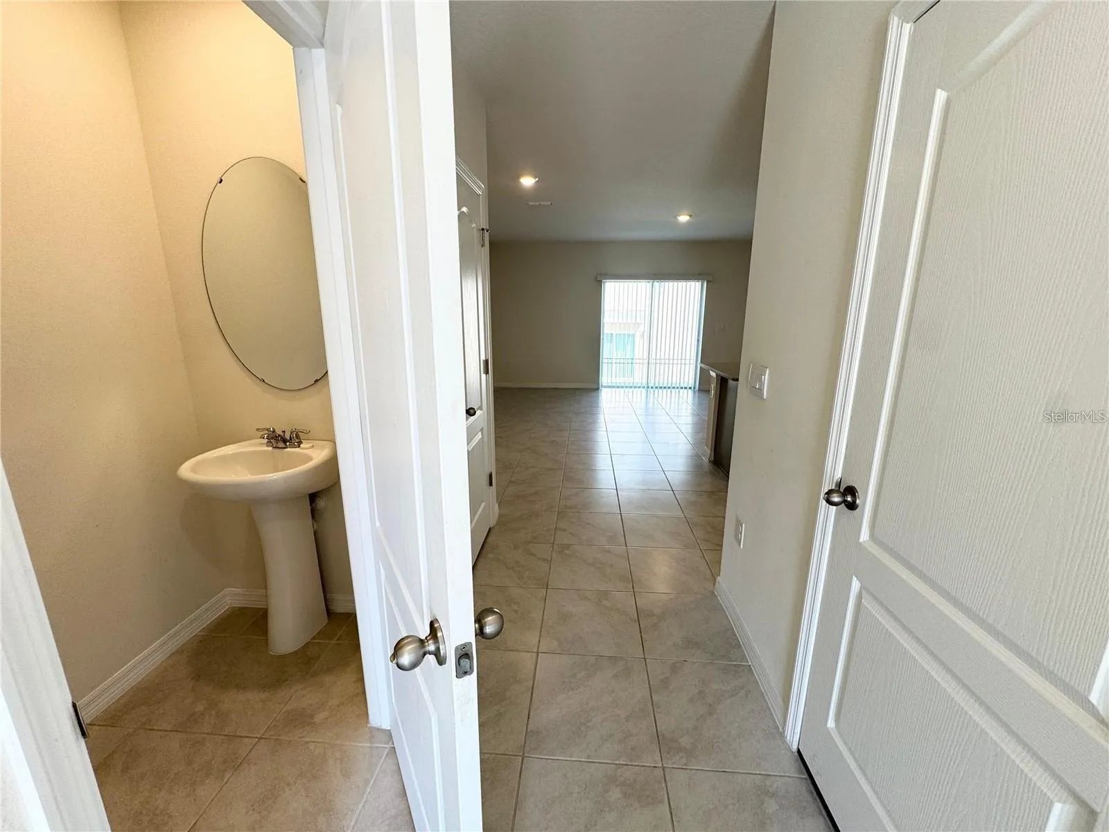 View from breezeway toward half bath, closet toward living room.