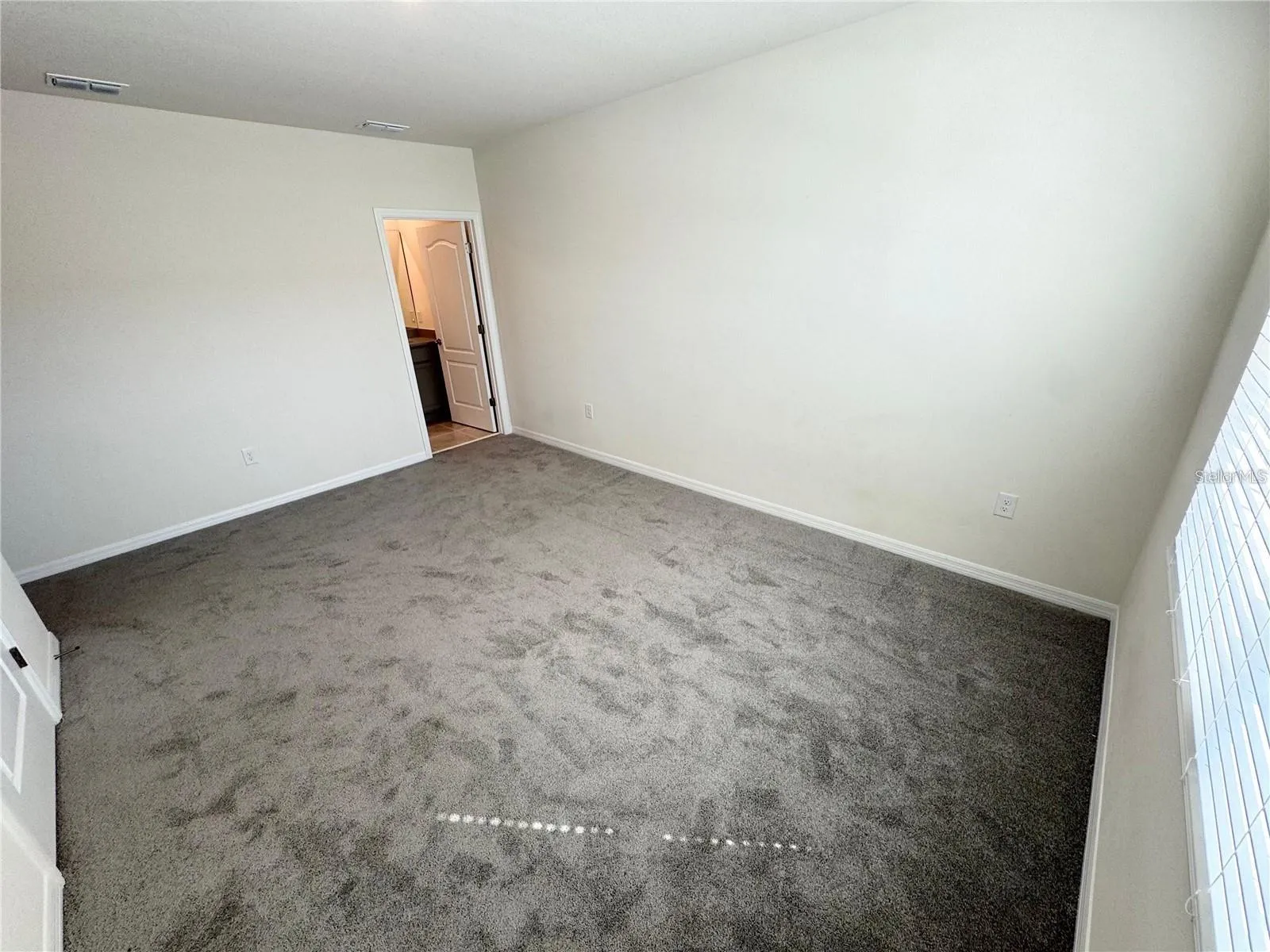 View of primary bedroom toward primary bathroom.