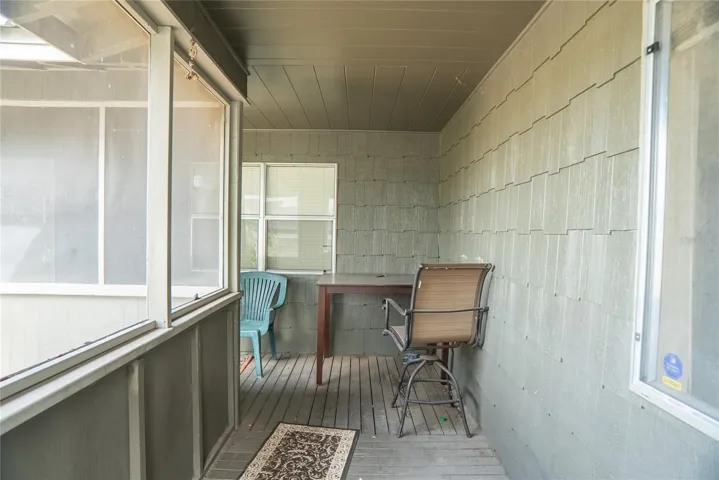 Wrap around front porch, screened in