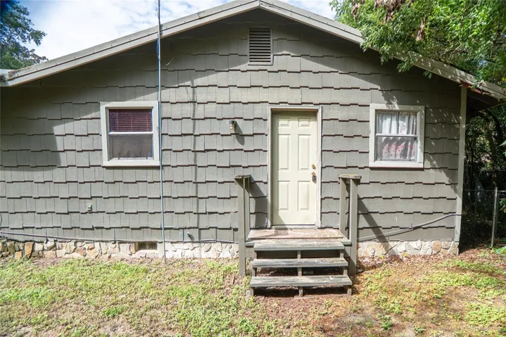Rear entrance at 311 S Thompson Avenue, DeLand, FL 32720. Rear stairs need repair; do not use.