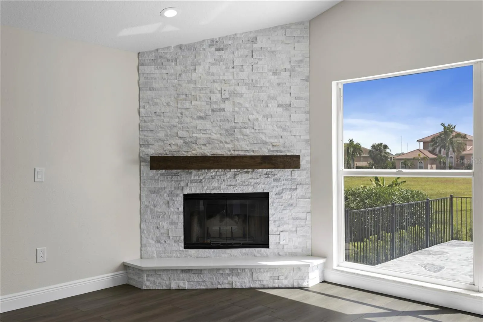 Beautiful wood-burning fireplace with elegant mantel and tile surround - a charming touch of character.