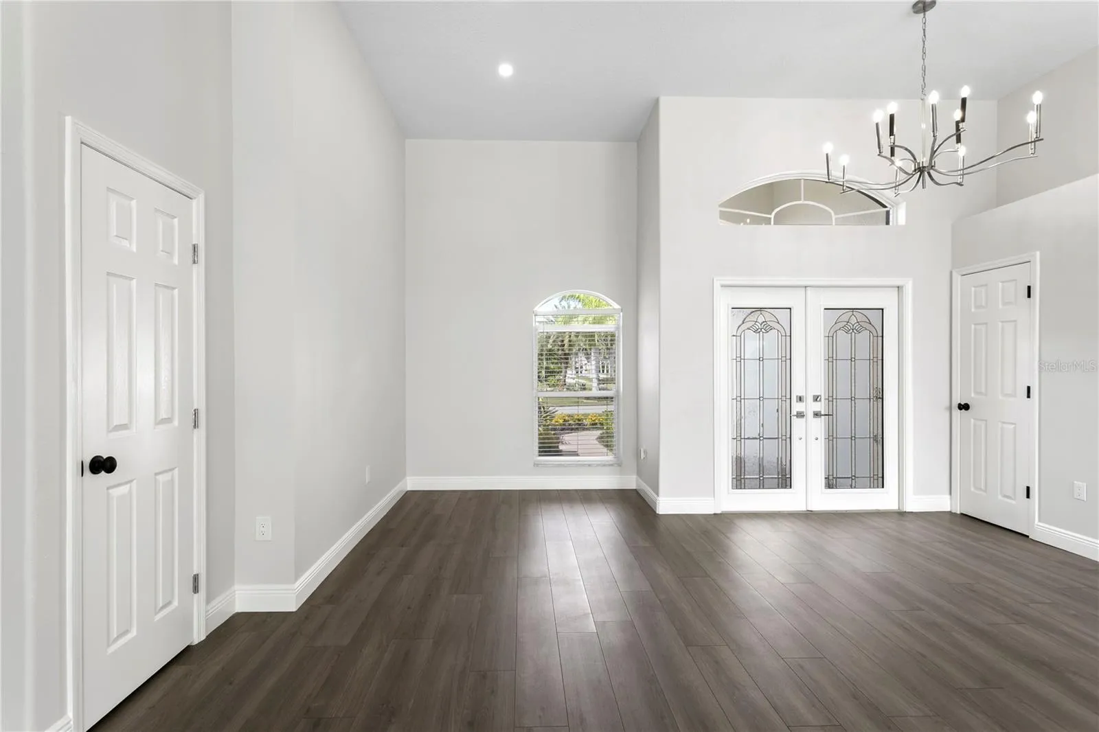 Welcoming double-door entry with beautiful lighting, ample storage and elegant laminate flooring carried throughout the home