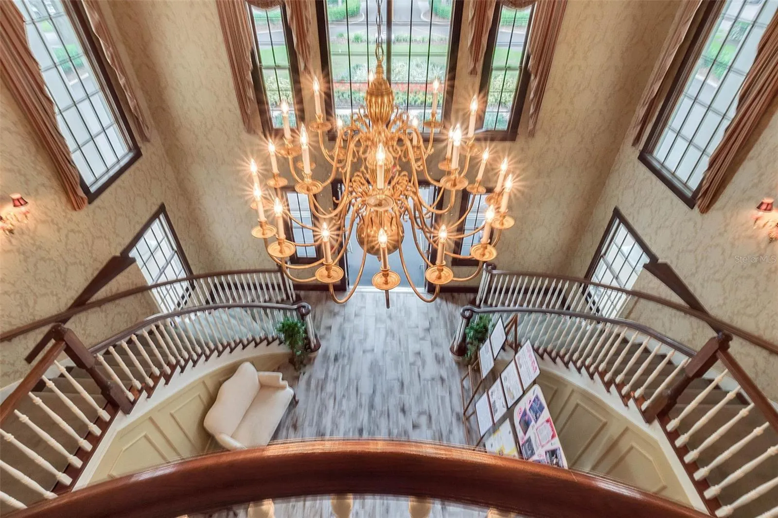 Community amenity: clubhouse foyer and chandelier seen from the upper landing