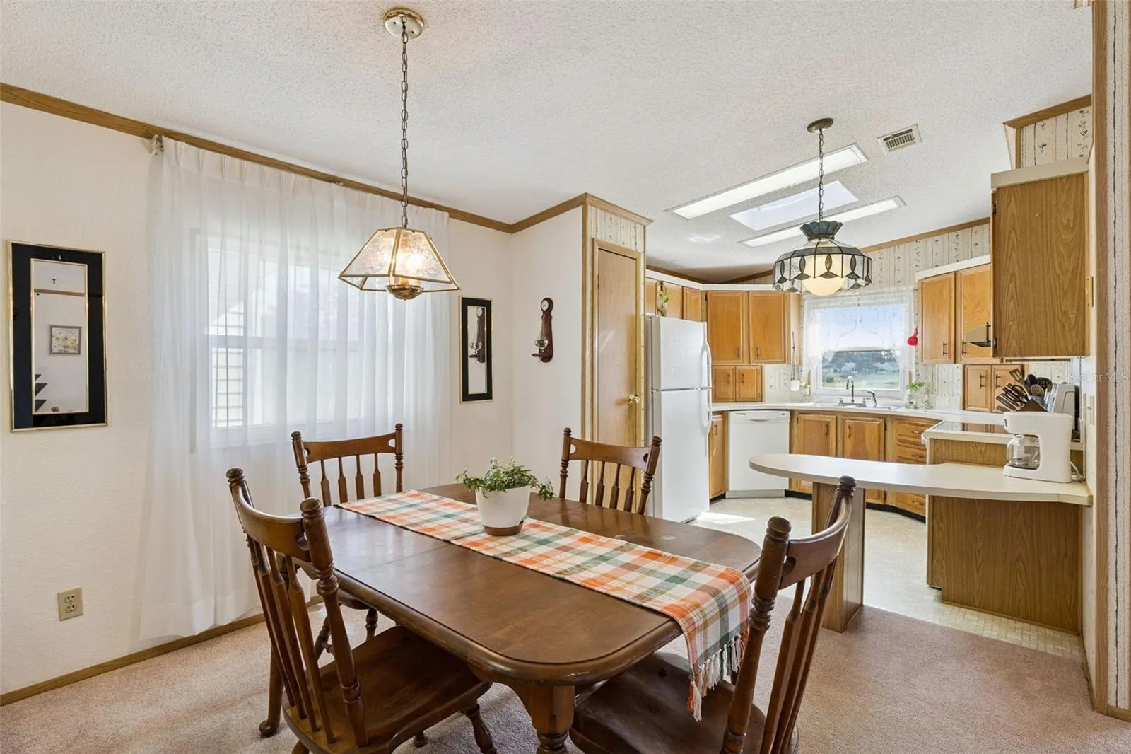 Dining room flowing into the kitchen and breakfast bar