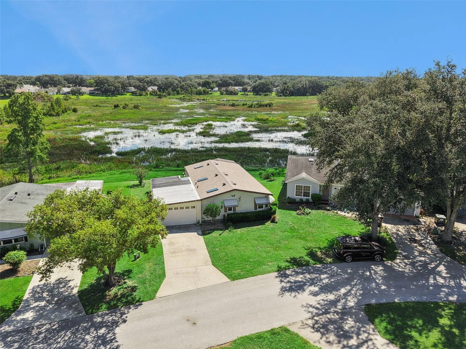 Aerial view of the home backing to the open marsh