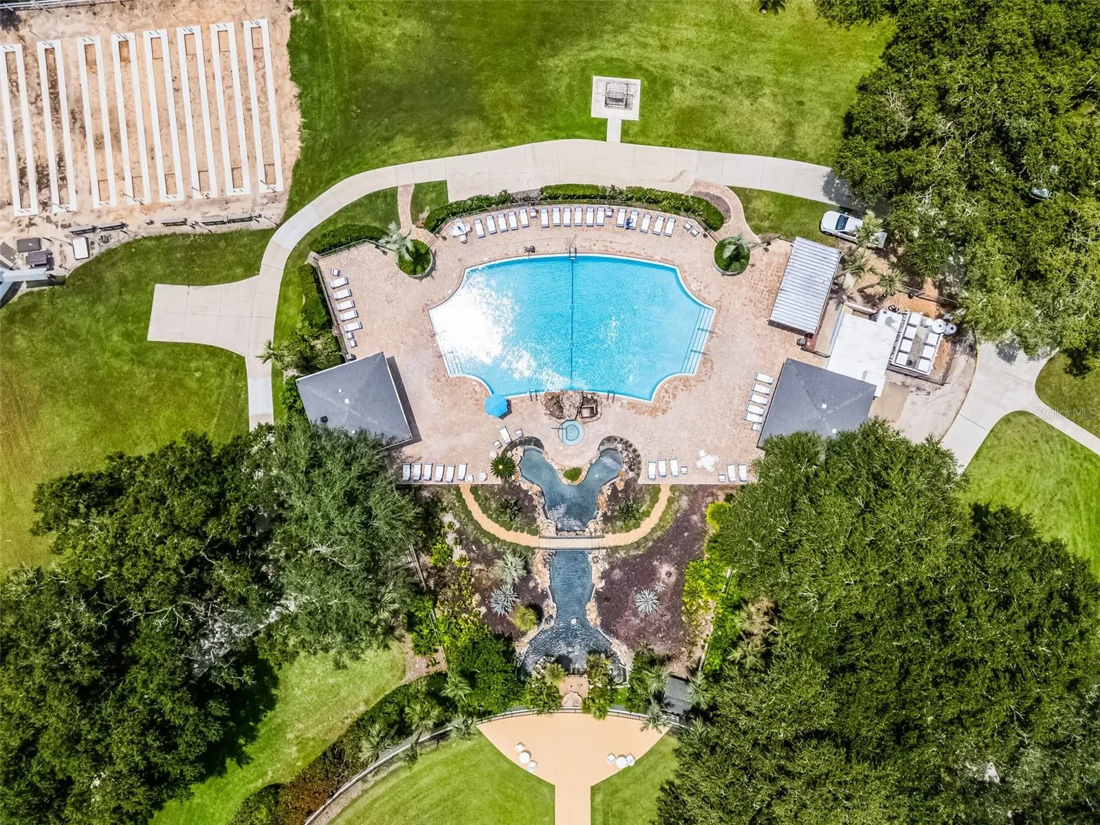 Community amenity: aerial view of the pool, waterfall and sun deck
