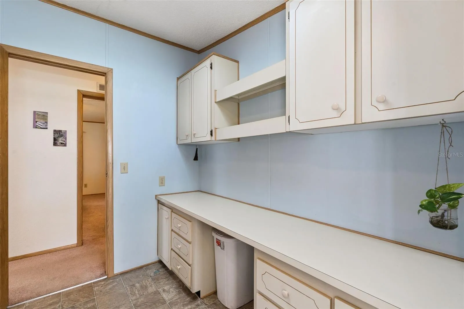 Laundry room with built-in counter, drawers and upper cabinets