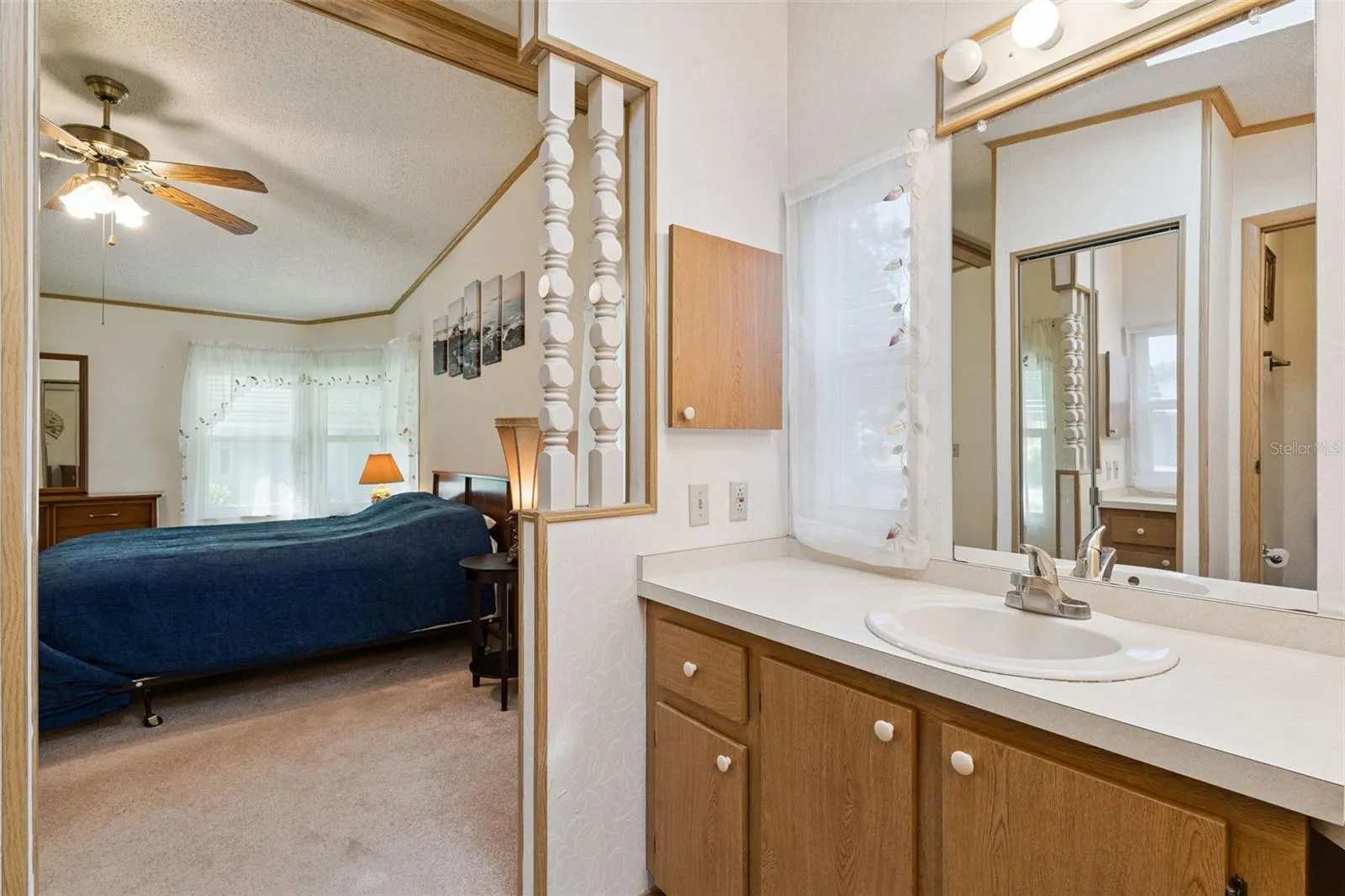Primary bathroom vanity open to the primary bedroom