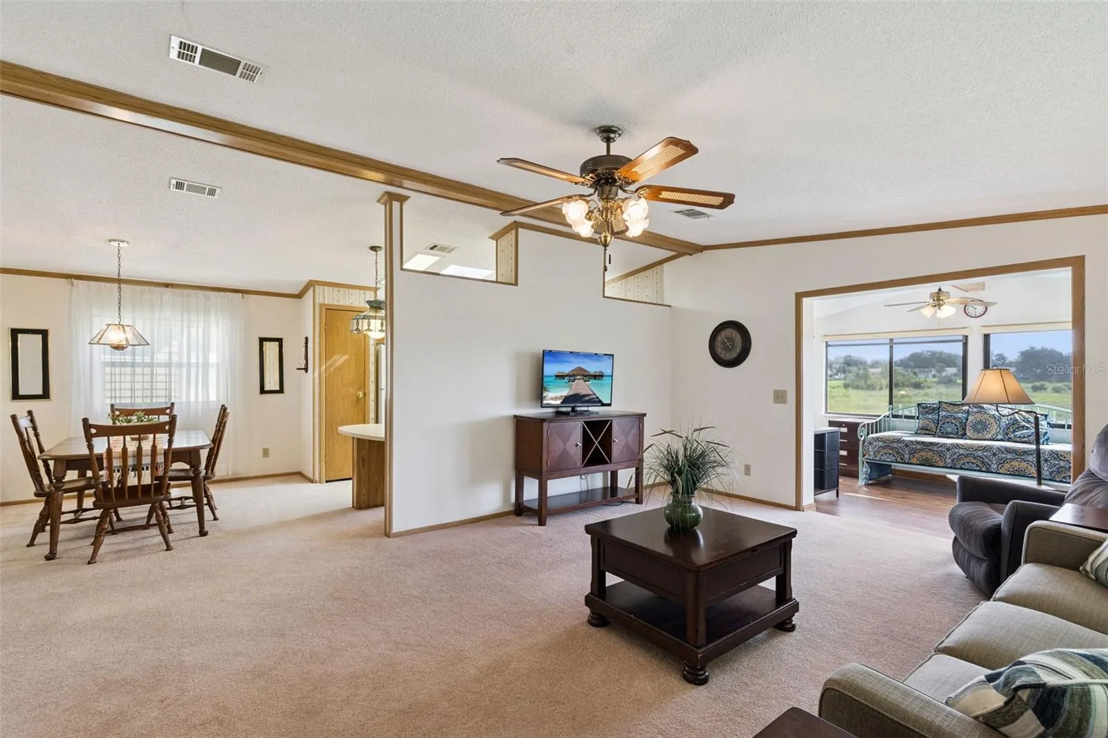 Open living area connecting the dining room and the sunroom