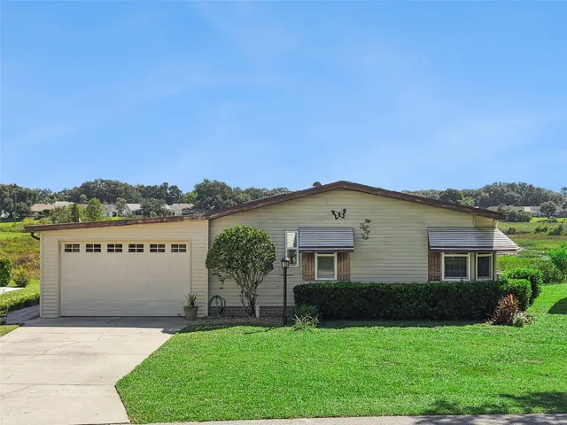 Elevated front view of the home with the open marsh and treeline behind