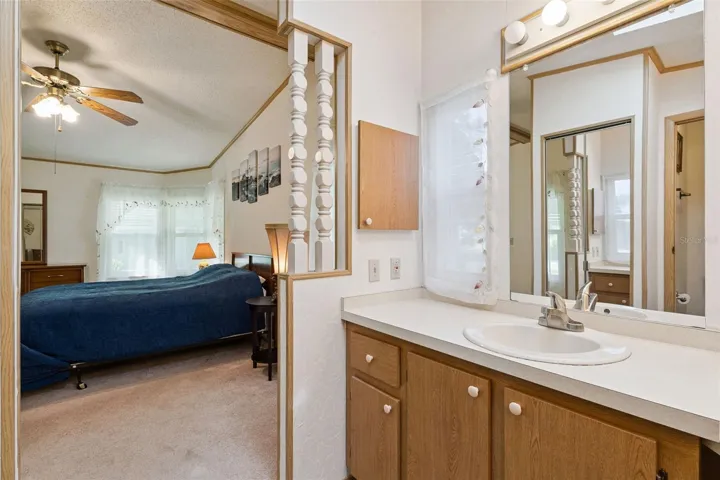 Primary bathroom vanity open to the primary bedroom