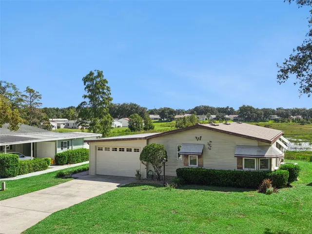 Elevated front view of the home and garage with the marsh beyond