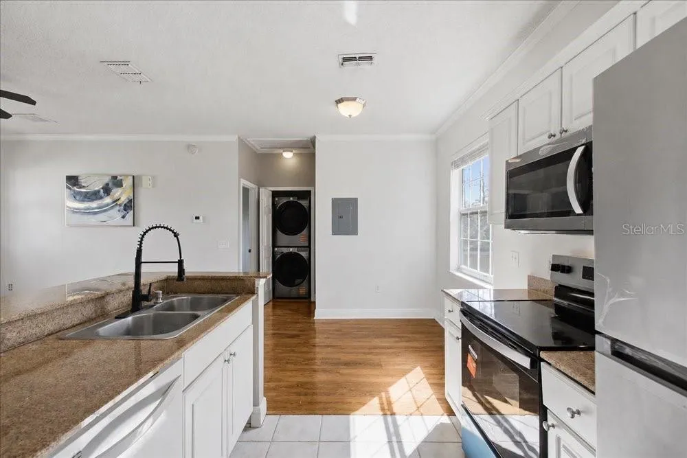 Appliances, counters, and laundry area.