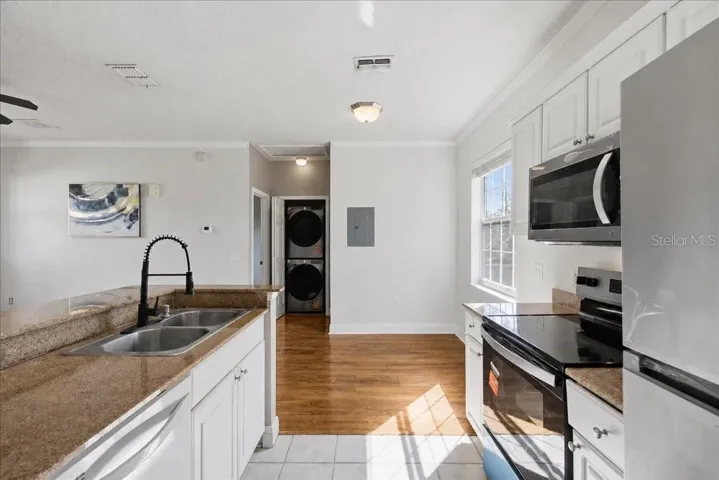 Appliances, counters, and laundry area.