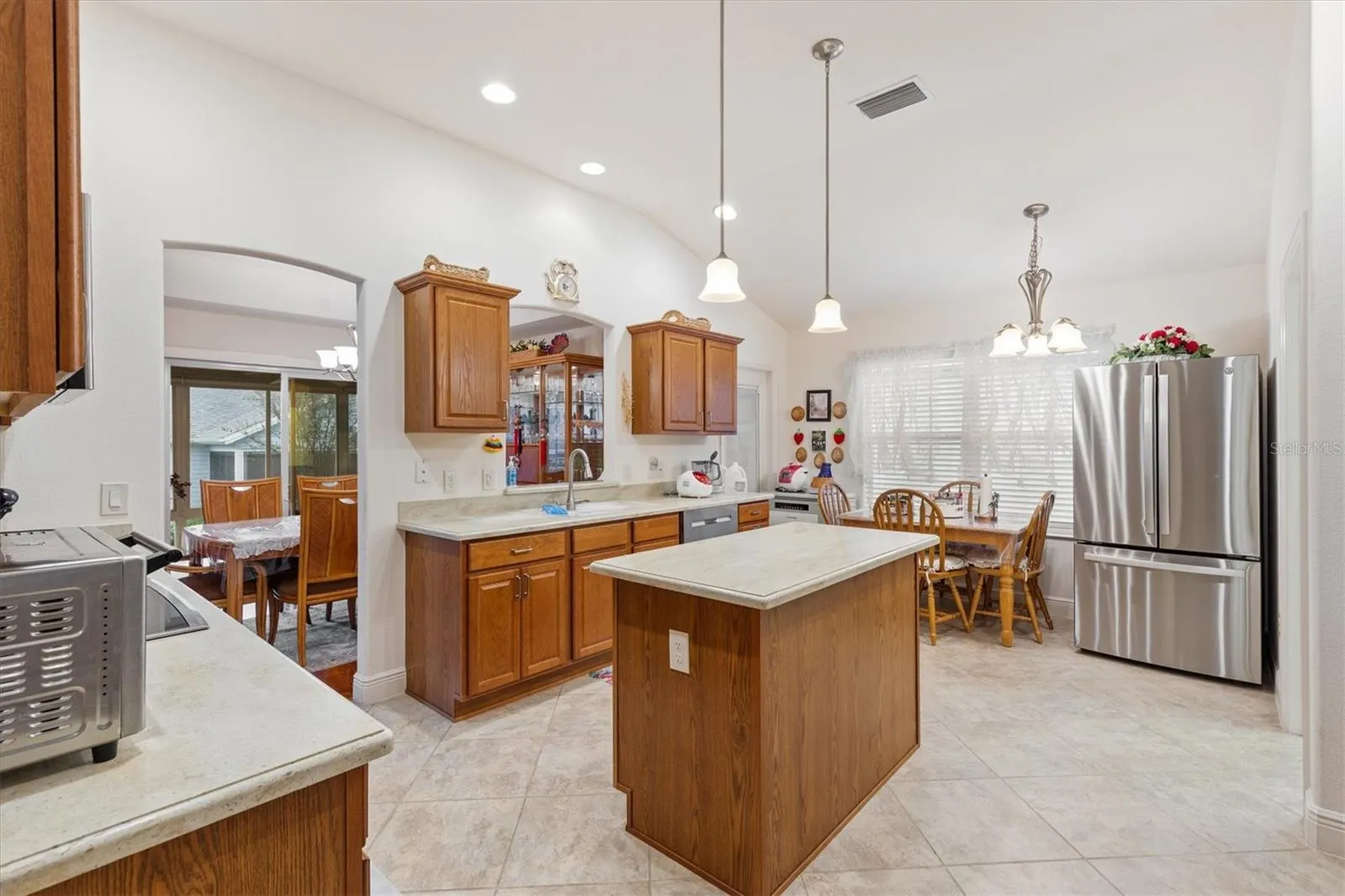 Large Kitchen with two refrigerators, built-in oven, cooktop, and working island.