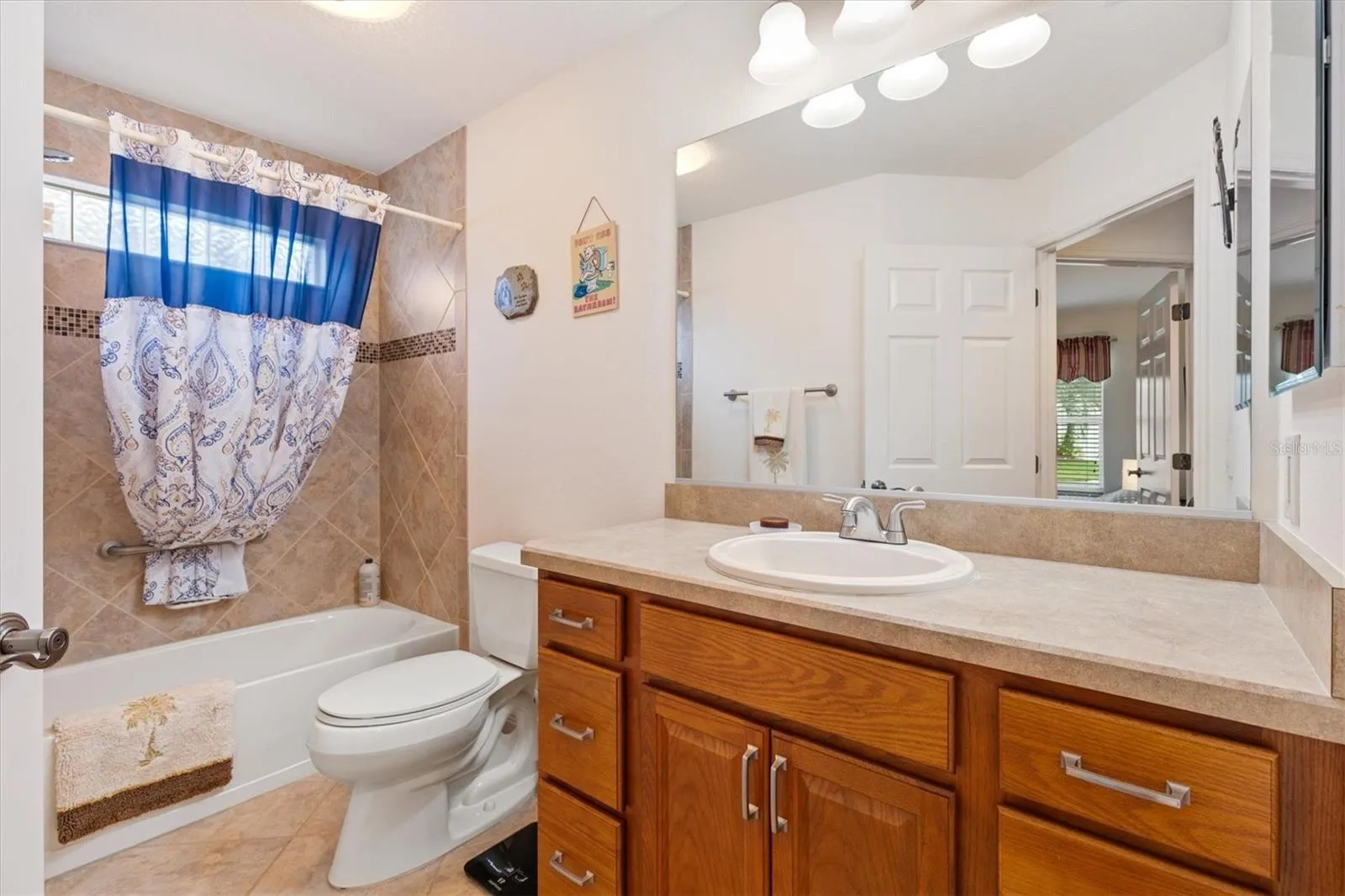 Guest bath with tiled tub/shower combo.