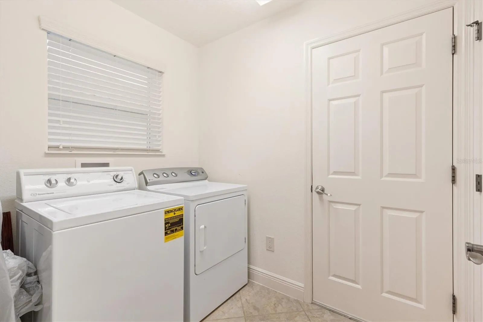 Inside laundry room with storage closet.