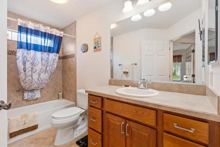 Guest bath with tiled tub/shower combo.