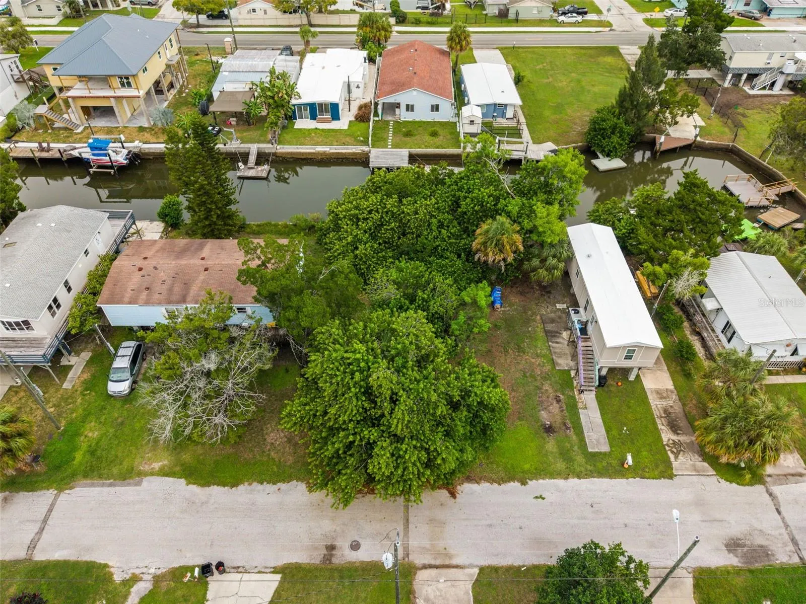 Aerial view showcasing this waterfront homesite and its desirable canal-side setting.