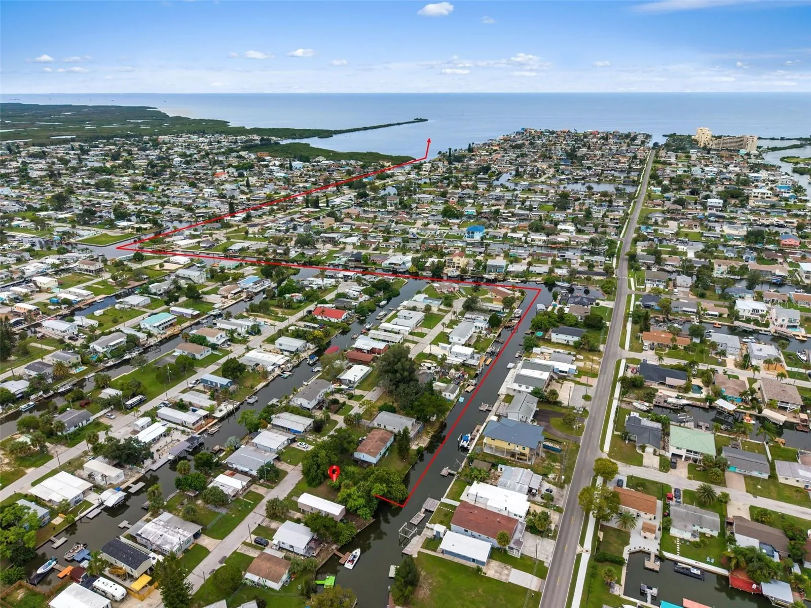 Aerial view highlighting the property location and approximate canal route leading toward the Gulf.