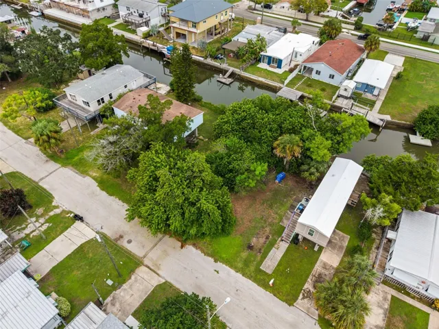 Elevated perspective showing the property’s canal frontage and established neighborhood surroundings.