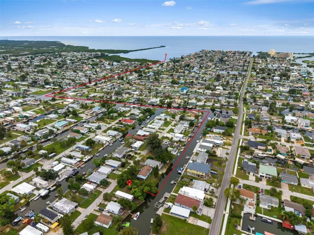 Aerial view highlighting the property location and approximate canal route leading toward the Gulf.