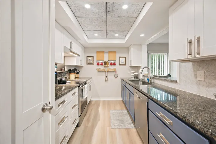 Remodeled Kitchen with Plenty of Storage Space - Detailed Textured Ceiling Panel - New Flooring - New Lighting Implemented