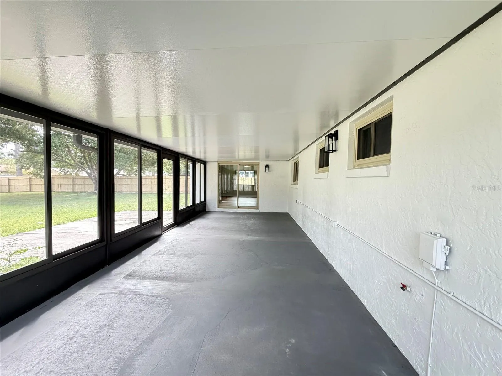 Large Encloded back Porch with insulated roof and glass windows