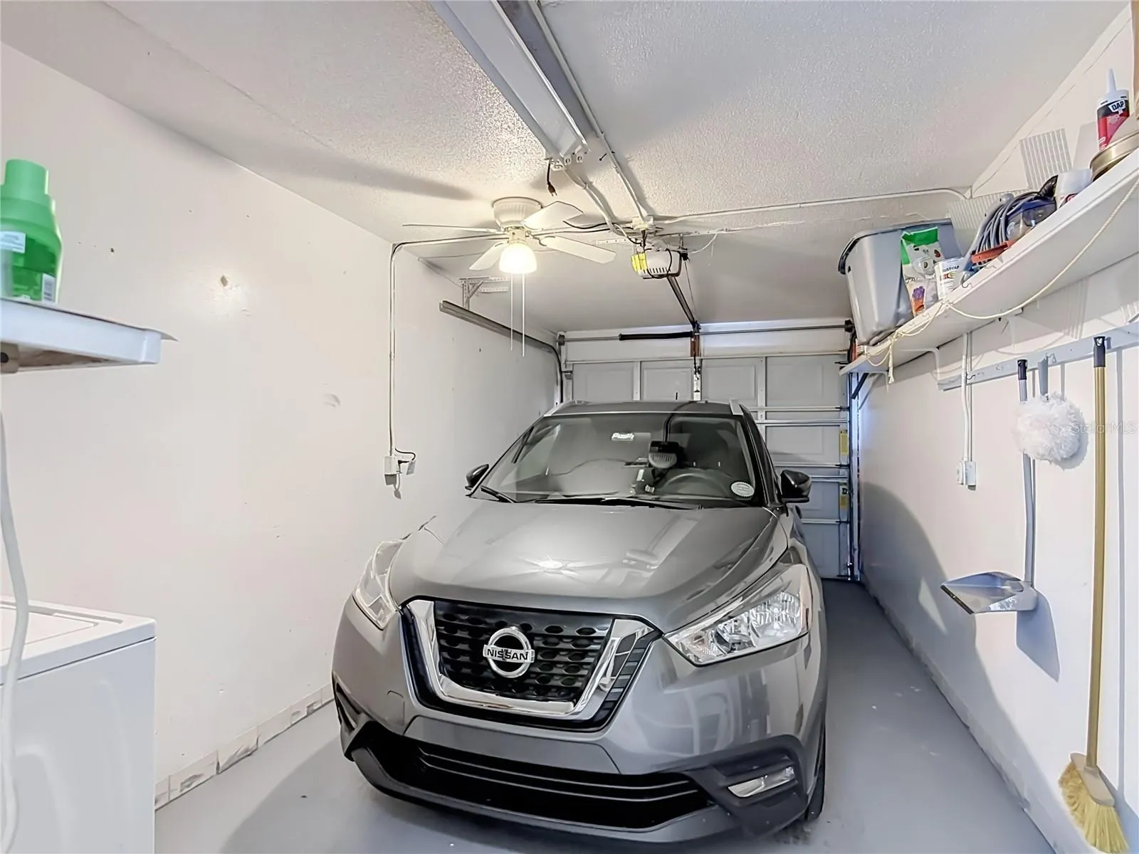 One-car garage with shelving.