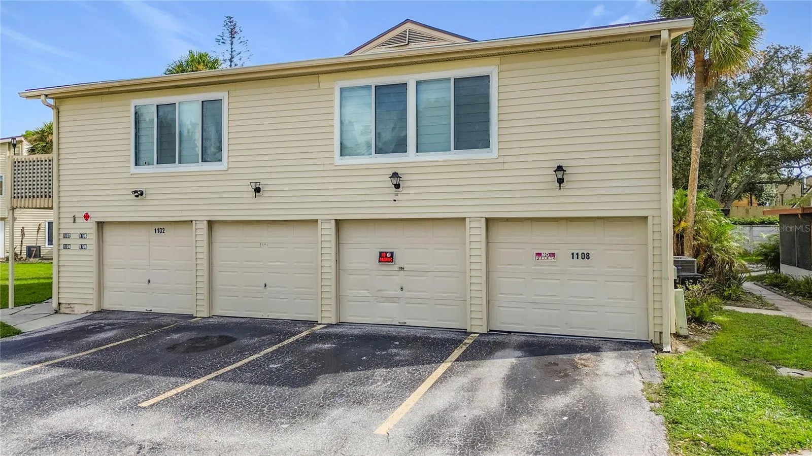 Exterior view with garage entrances.