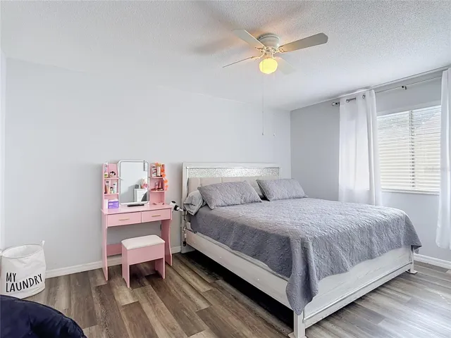 Second bedroom with wood-look flooring.