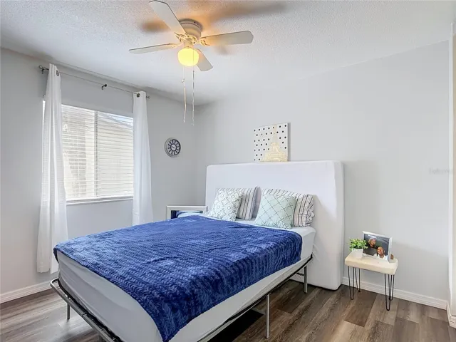 Bright bedroom with ceiling fan.