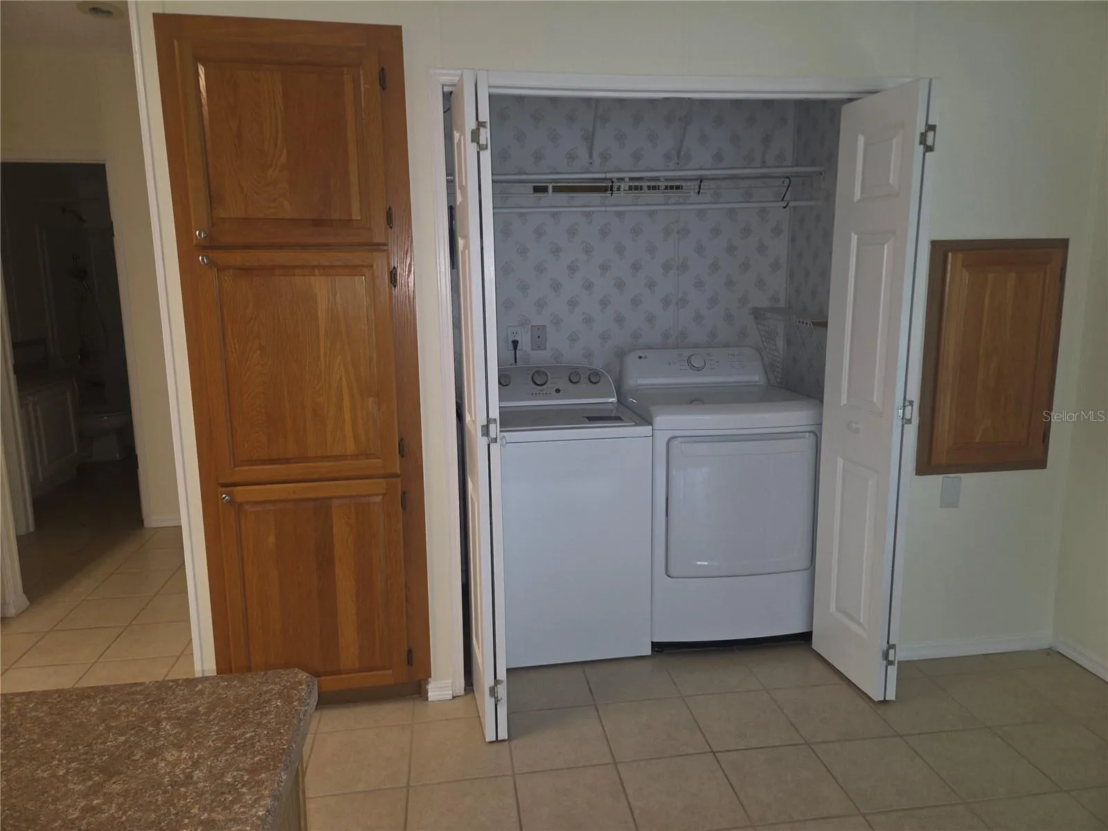 Kitchen dinnett area has washer and dryer tucked in here