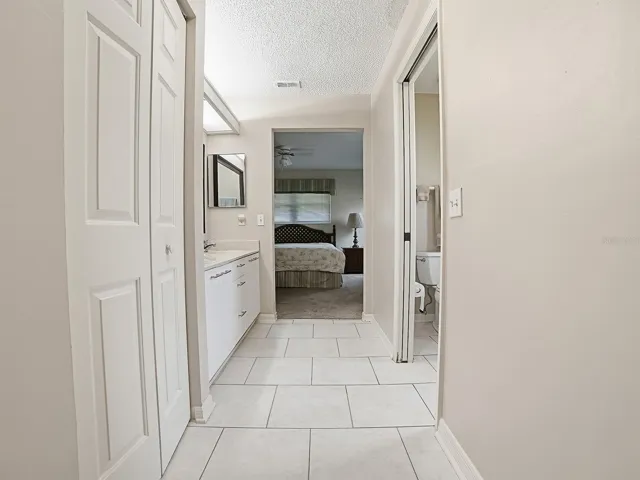 VIEW FROM PRIMARY BEDROOM THROUGH BATHROOM AND TO THE CRAFT/OFFICE/LAUNDRY AREA