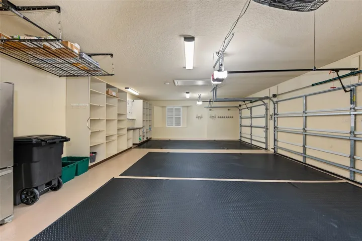 Oversized 3 car garage with epoxy flooring, storage and 3 electric car chargers