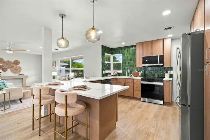 Open kitchen with quartz counters.