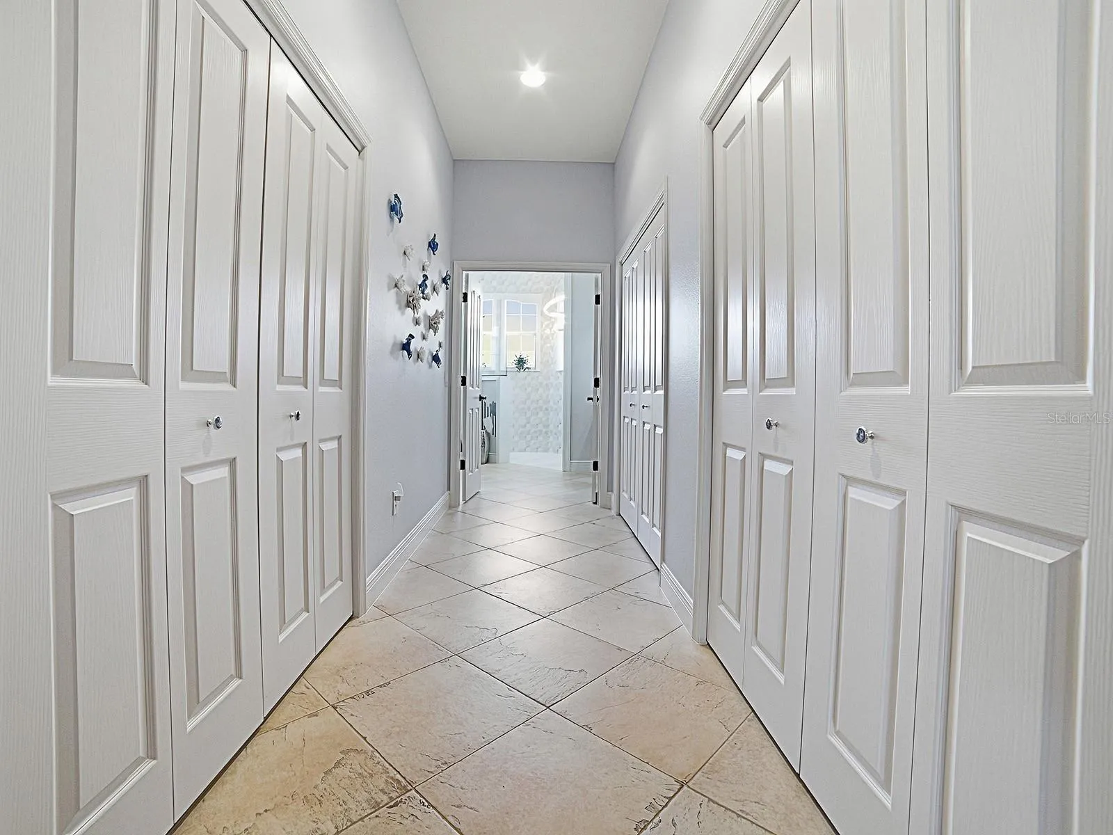 LARGE WALK-IN CLOSET ON THE LEFT WITH SOLAR TUBE, AND ON THE RIGHT MORE CLOSET SPACE. THE 2ND SET OF DOUBLE DOORS ON THE RIGHT HAS MORE STORAGE AND 2ND WATER HEATER - CONVENIENT FOR THIS SIDE OF THE HOME.