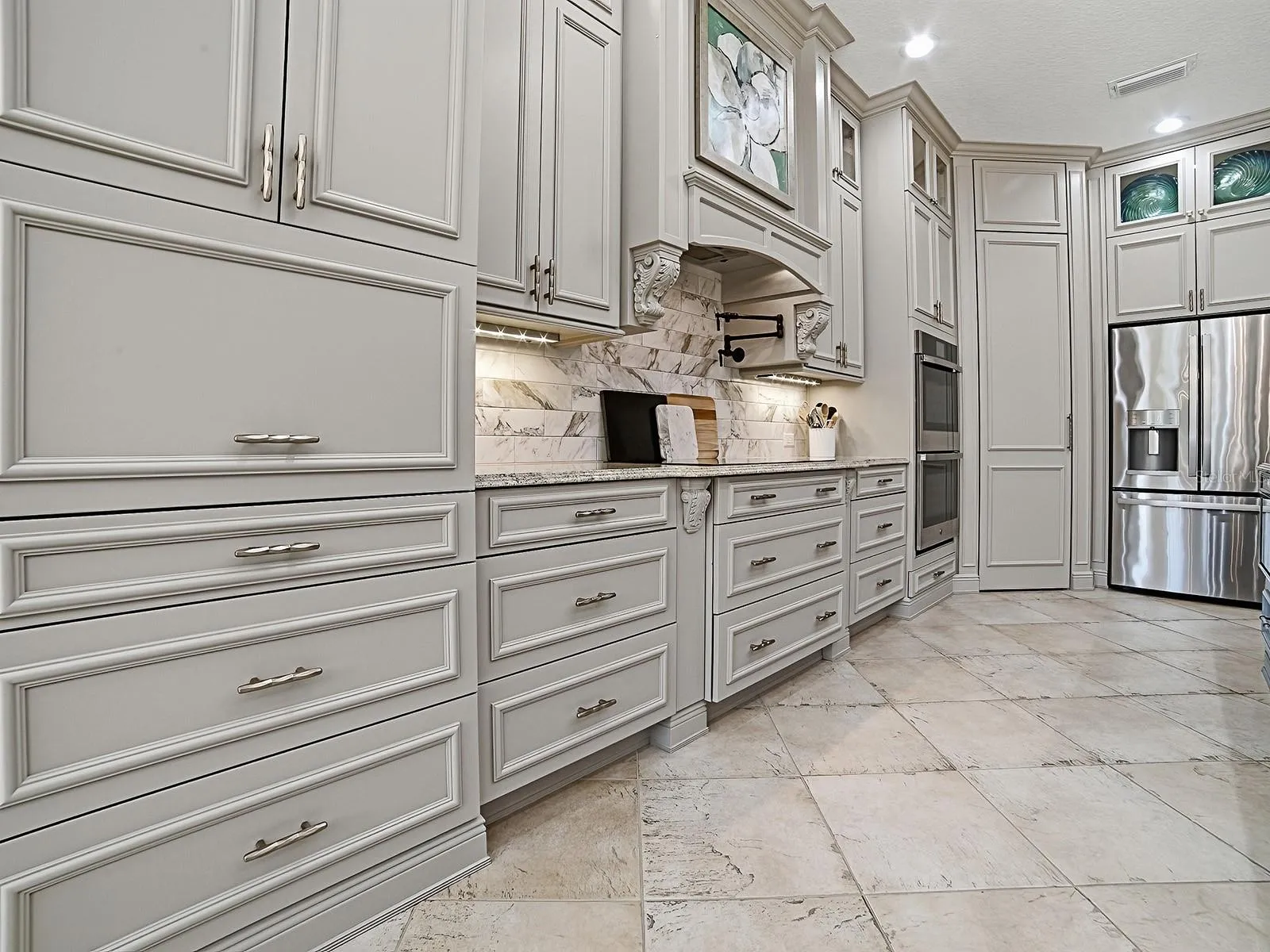 THE APPLIANCE GARAGE CLOSED IN THIS PHOTO, LOVELY TILED BACKSPLASH AND MANY LIGHTING OPTIONS.