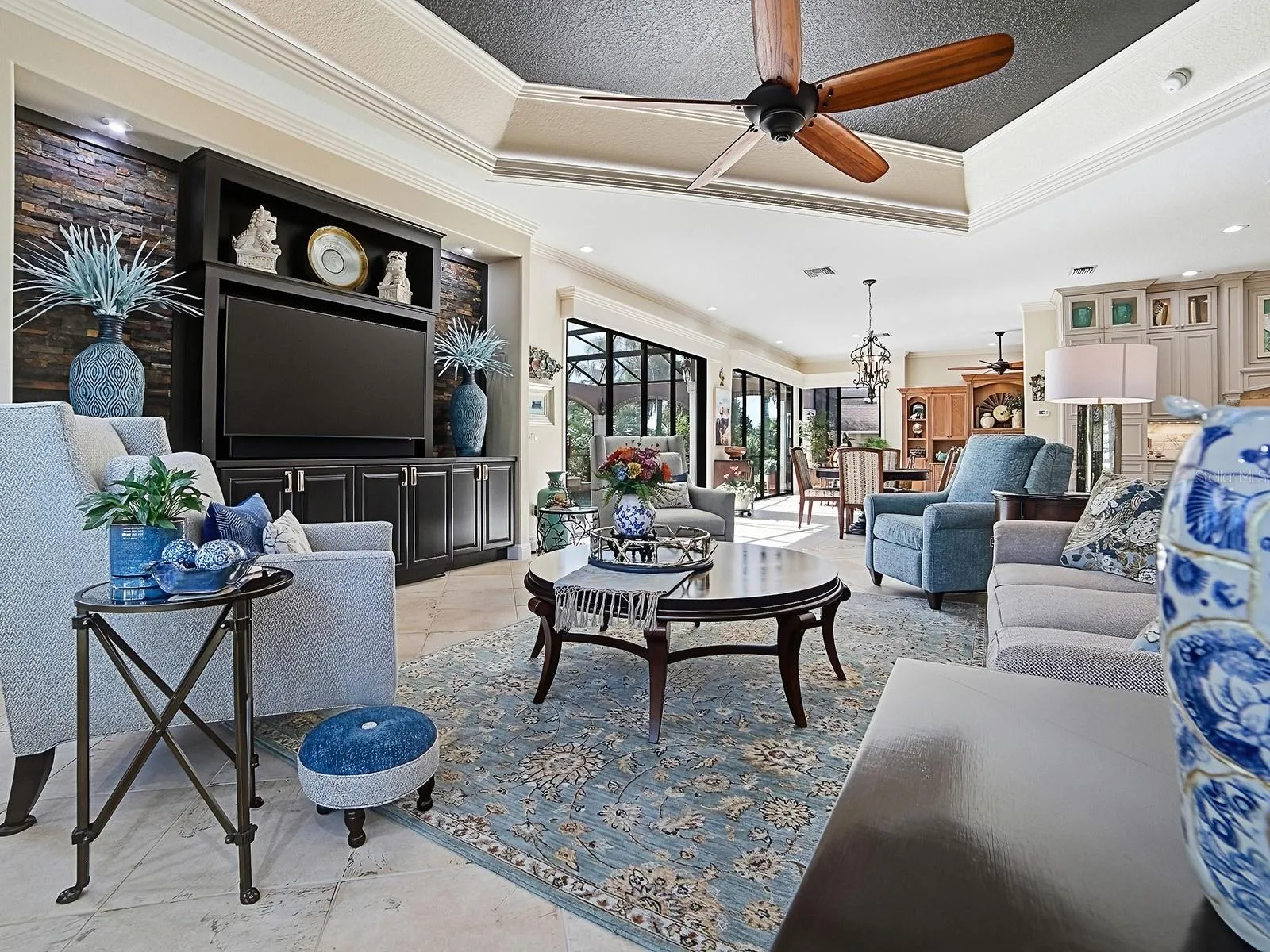 WHAT A BEAUTIFUL FAMILY ROOM WITH CUSTOM BRICK WALL SURROUNDING THE BUILT IN WALL UNIT AND CABINETS.