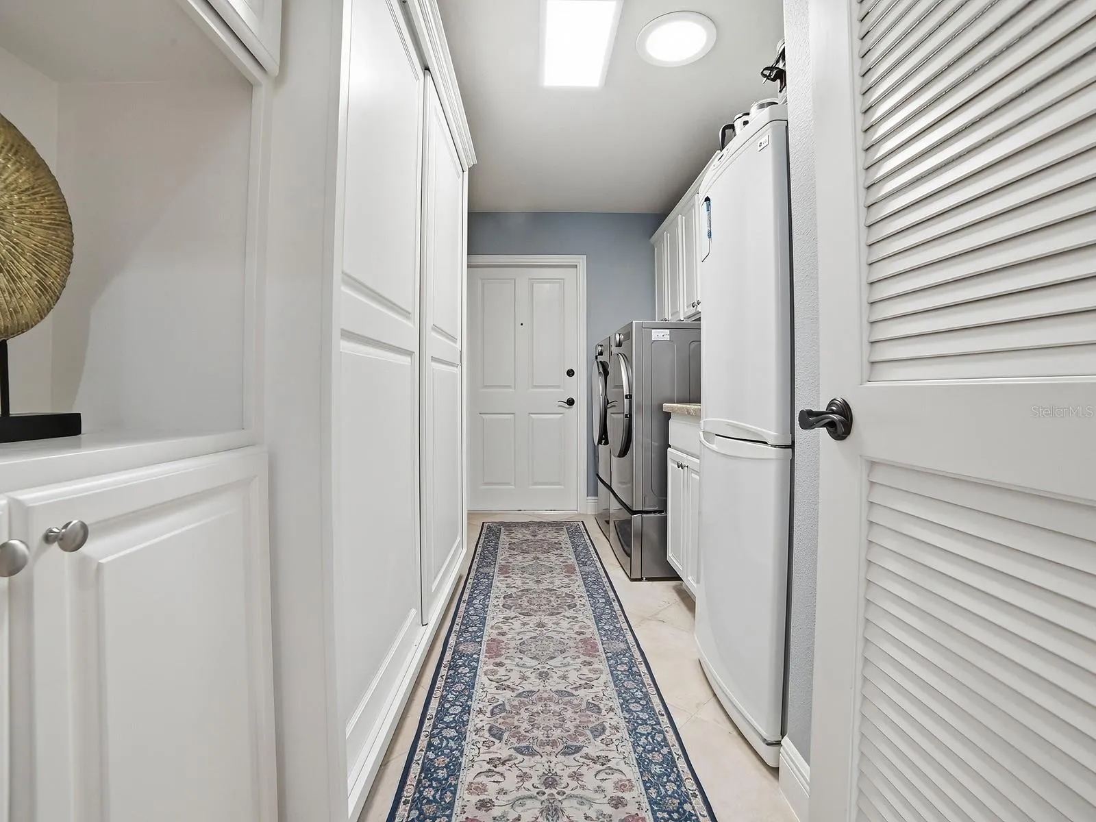 THE LAUNDRY ROOM HAS A NEW FRONT LOAD WASHER AND DRYER, A SINK, AND ALL THE CABINET SPACE YOU SEE HAS BEEN ADDED OFFERING SO MUCH EXTRA STORAGE. AN AREA FOR HANGING CLOTHES, SUPPLIES, AND EVEN A BROOM CLOSET.