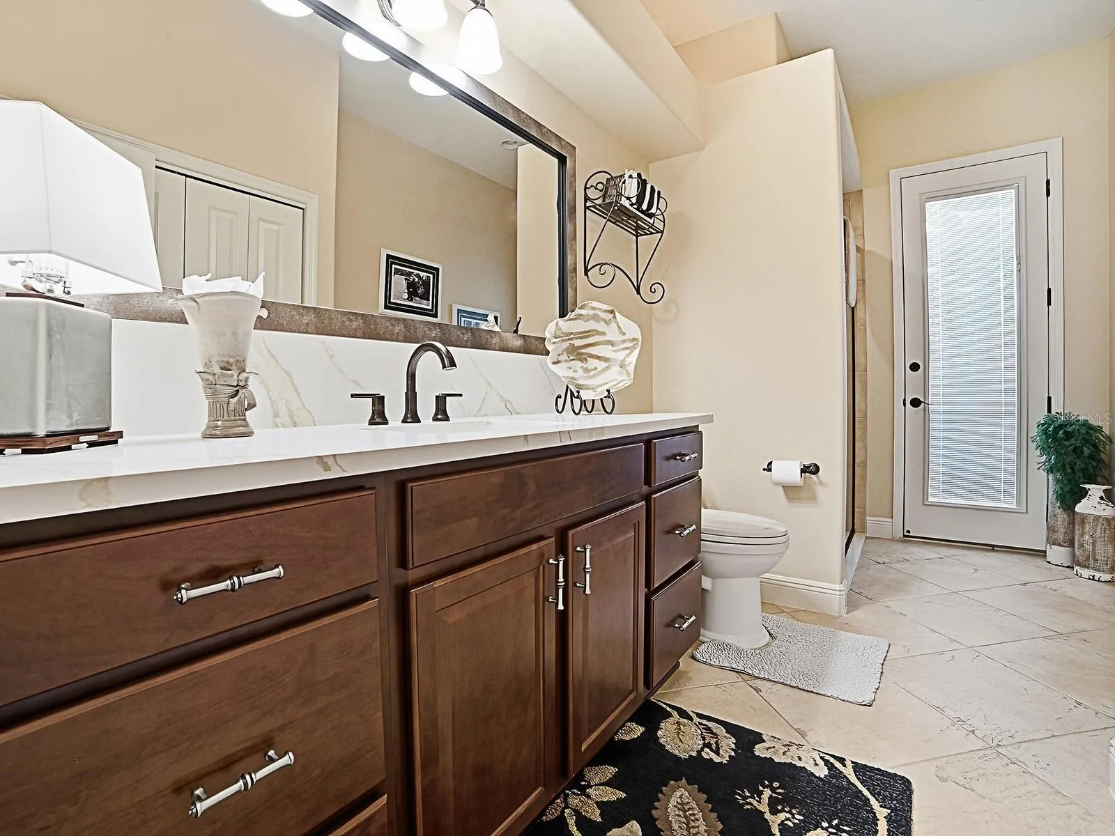 ACROSS THE HALLWAY FROM THE 3RD BEDROOM IS THE 3RD "POOL" BATH OFFERING ACCESS FROM THE INSIDE AND OUTSIDE.  THERE IS A SHOWER TO THE LEFT AND LARGE LINEN CLOSET ON THE RIGHT.