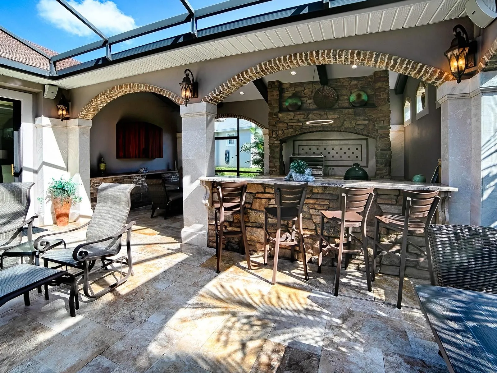 A GREAT PLACE FOR ENTERTAINING WITH THE SUMMER KITCHEN OFFERING AN ALFREDO GRILL AND REFRIGERATOR.