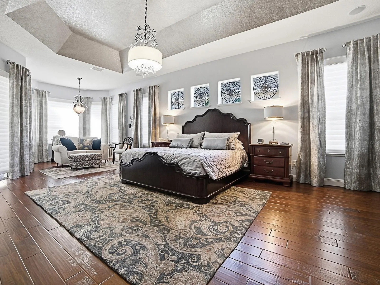 PRIMARY BEDROOM - WOW! HARDWOOD FLOORING, CUSTOM DRAPES, CUSTOM FIXTURES - A SPECTACULAR, SPACIOUS ROOM!