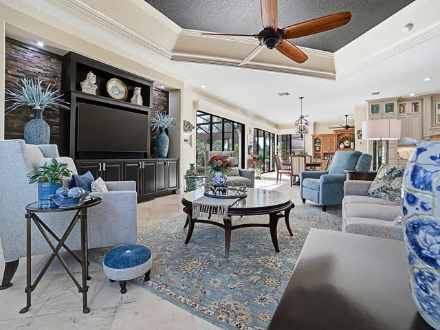 WHAT A BEAUTIFUL FAMILY ROOM WITH CUSTOM BRICK WALL SURROUNDING THE BUILT IN WALL UNIT AND CABINETS.